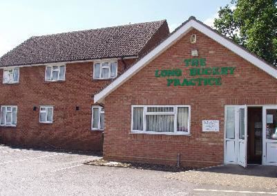 a large brown brick building next to a house